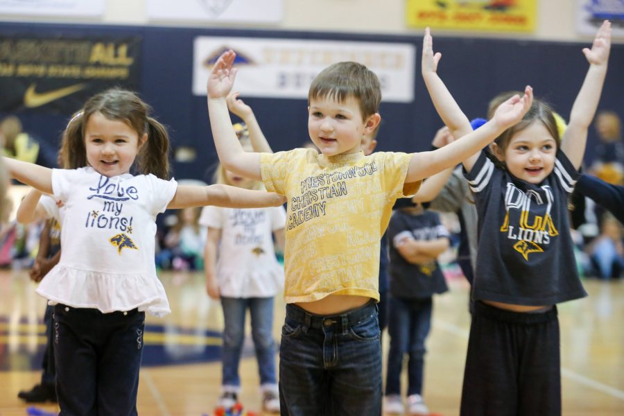 Pre-K 4 students Shaylin Nolan, Case Callander and Lucy Henrie get moving during the P.E. Showcase.