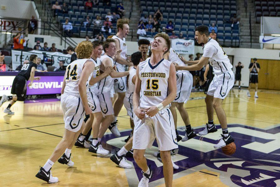 Junior Beck Atkins and the rest of the Varsity Boys Basketball team celebrate mid-court after winning their sixth TAPPS Division 1 State Championship in a row. The team defeated district rival Bishop Lynch, 45-42.