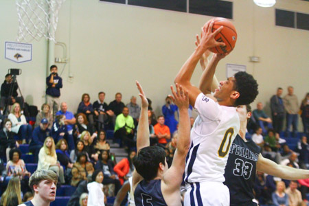 Junior Justin Webster goes up for the basket against Bishop Lynch. The Lions went on to win, 56-54.