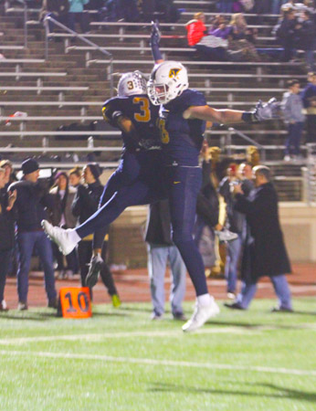 Senior Ricky Baker and Junior Austin Stogner take to the air after Bakers second quarter touchdown.