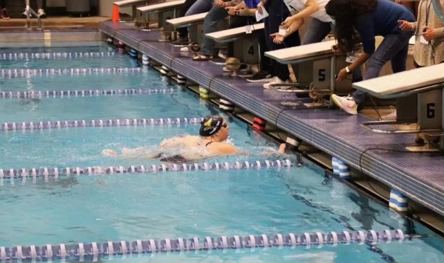 Sophomore Lauren DenBraber finishes into the wall on her 500 yard freestyle at the Pre-Regional Meet.
