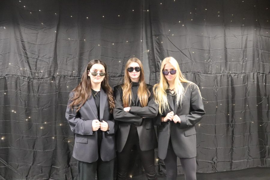 Senior girls pretend to be in the Secret Service on Career Day.