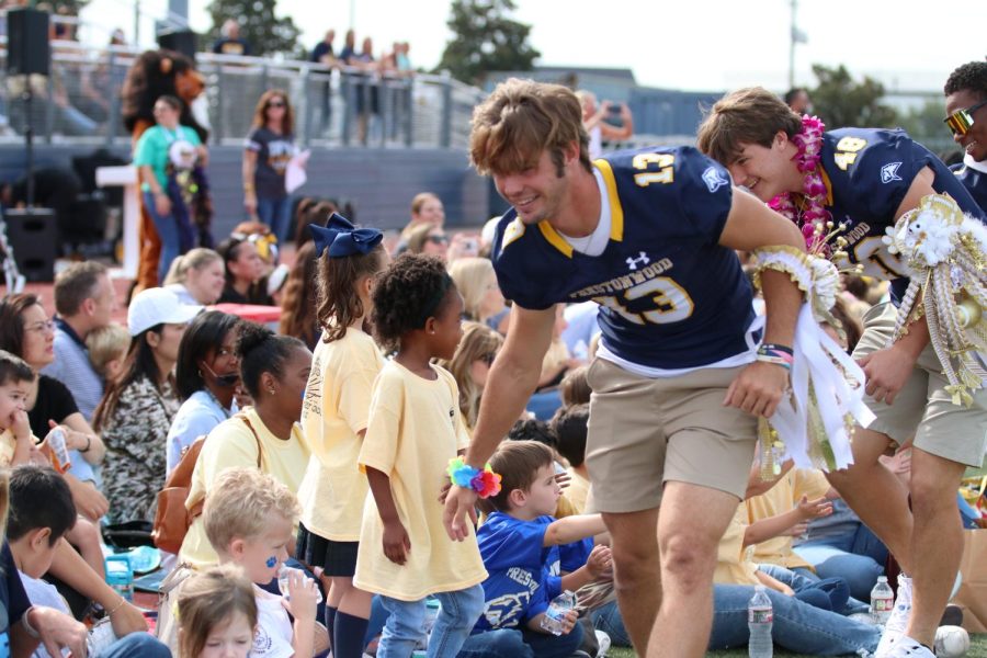 Maguire Martin high-fives some lower school students during the parade.
