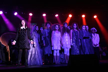 A cast of zombies backs up Sophomore Mollie-Claire Matthews as Wednesday Addams during Fall Follies.