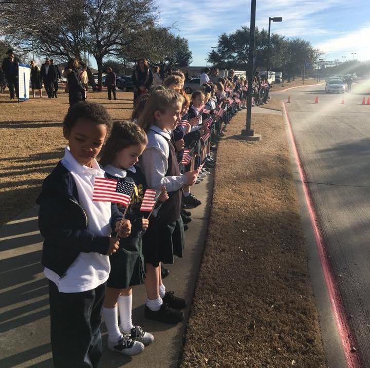 Students from First grade teacher Laura Mitchell's class line the sidewalk in honor of fallen Little Elm Police Officer, Detective Jerry Walker.