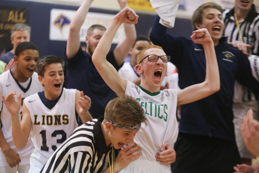 Referee Junior Beck Atkins celebrates with the MVP just after the final buzzer of the Special Friends Basketball Game.