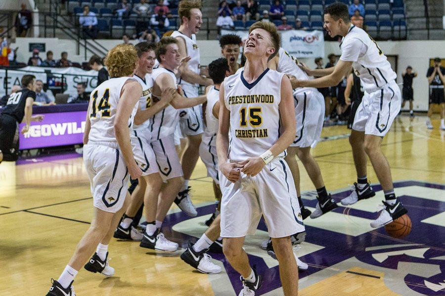 Junior Beck Atkins and the rest of the Varsity Boys Basketball team celebrate mid-court after winning their sixth TAPPS Division 1 State Championship in a row. The team defeated district rival Bishop Lynch, 45-42.