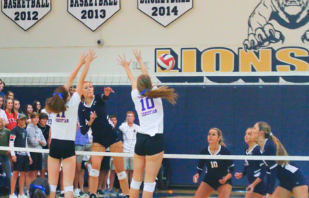 Senior Caroline Dow goes up for the kill against Trinity Christian. The Varsity Volleyball team has advanced to play in the State Semi-Final game Friday.