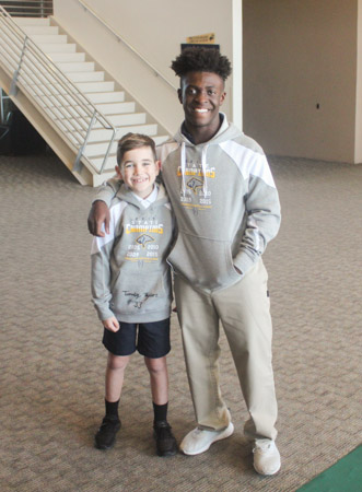 Fourth grade student Wyatt Neale wears the autographed State Championship hoodie given to him by his favorite Varsity Football player, Tim Taylor.