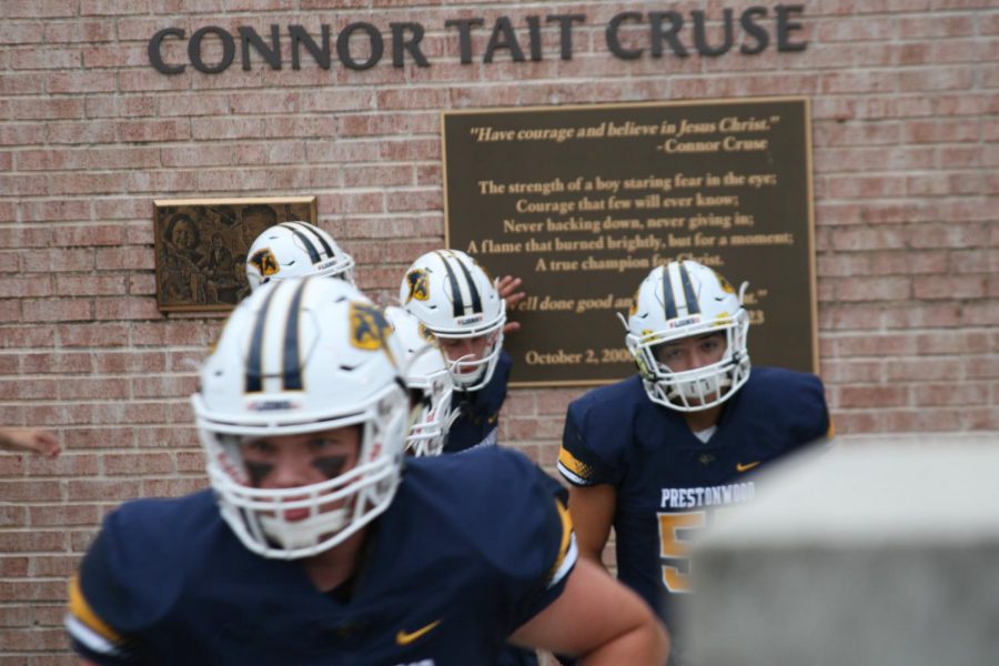 Players thoughtfully give tribute and remember their classmate Connor Cruse before they take the field.