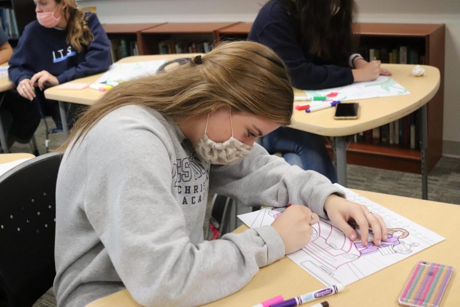 Sophomore Grace Palmer works on a piece of artwork during Upper School English Teacher Mrs. Pam Merryman's chapel break-out session. 