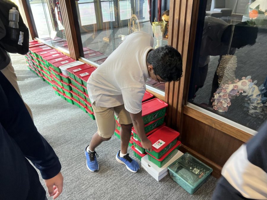 Upper School Student Ben Oommen stacks Operation Christmas Child boxes