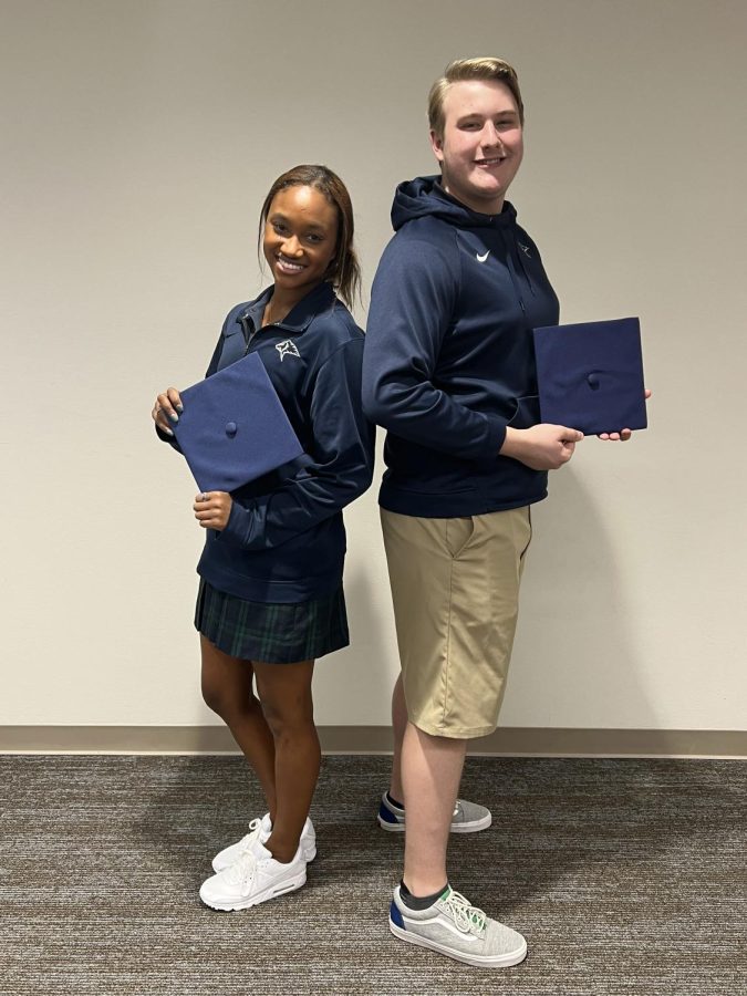 Seniors Matthew Mitchell and Maia Brown pose with graduation caps.