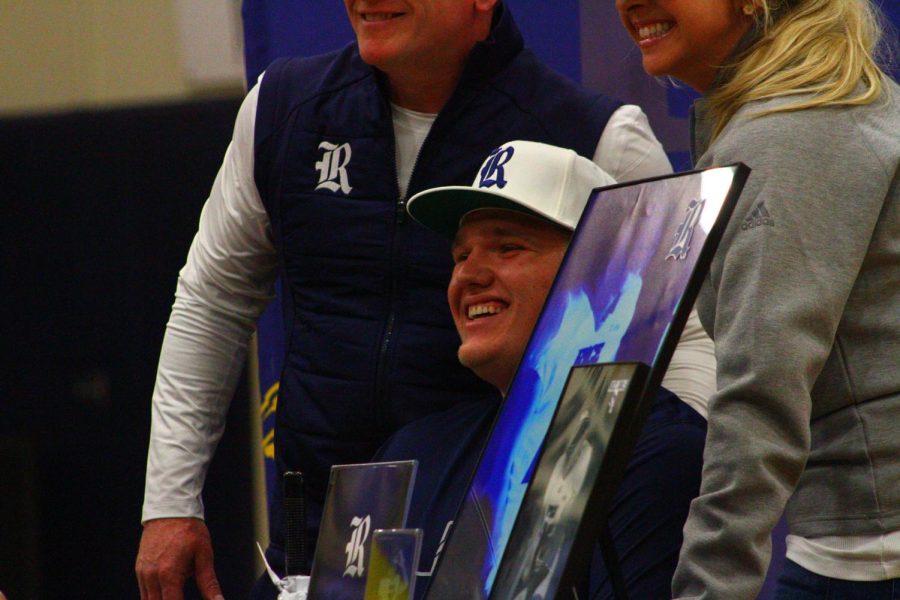 Trace Norfleet and his family posing for a photo at his table at the Signing Day.