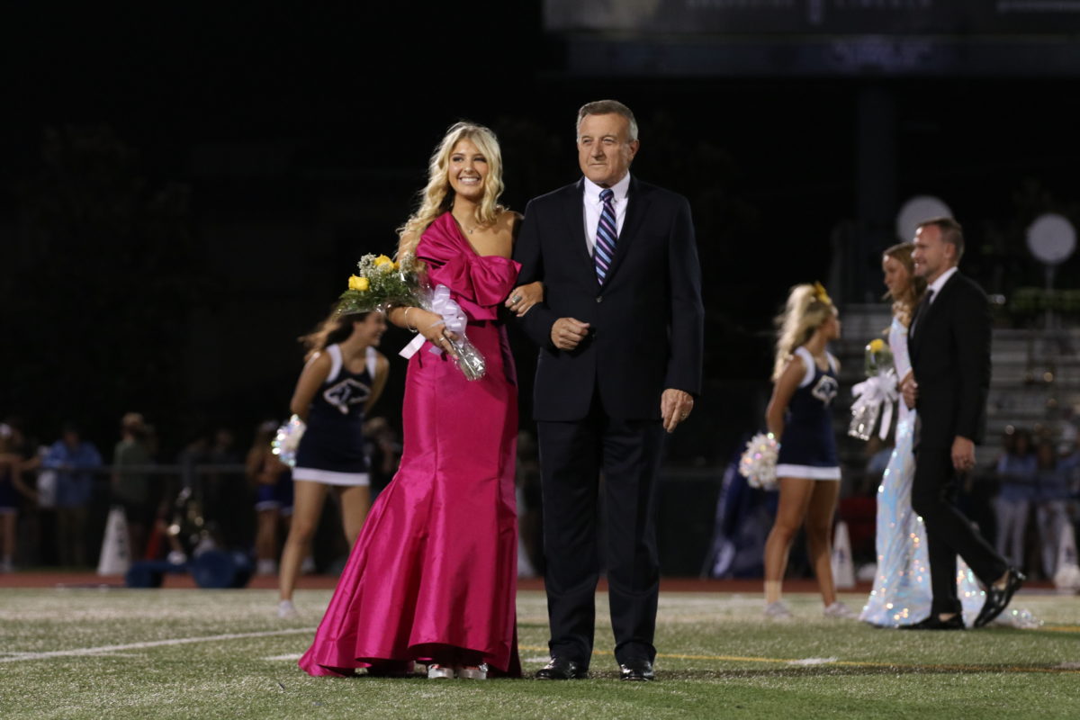 Junior (now Senior) Lauren Lineberger walks across the football field at the 2022 Homecoming game