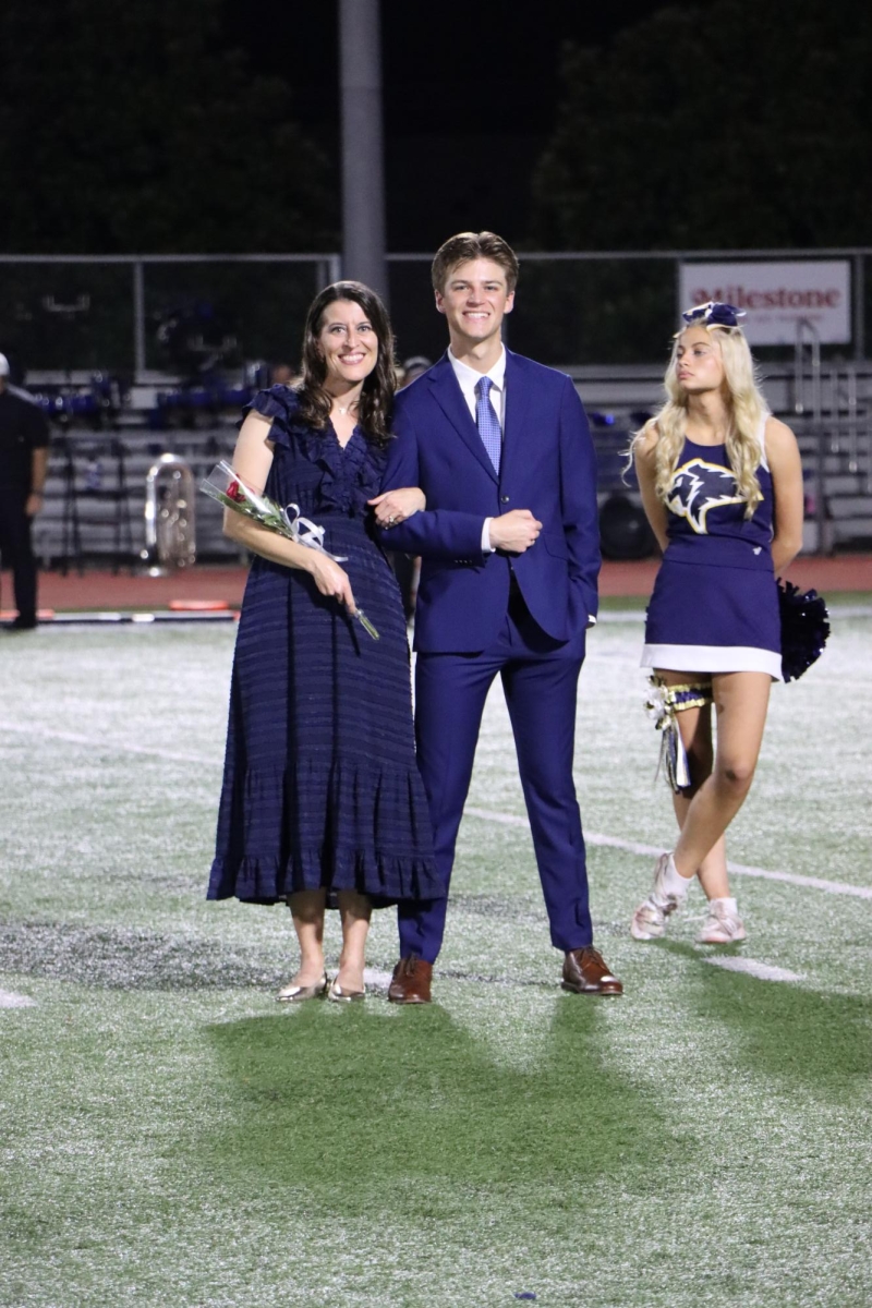 Junior Blake Dunham waits for the homecoming queen and king announcement alongside his mom  Jenna Dunham.