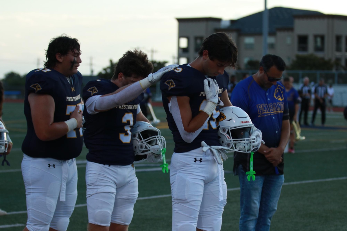 Campbell Panetti (12), Brady Palmer (12), and Daniel Jaffe (12) pray together. Photo by Brenna Callander.