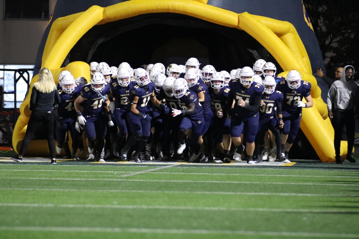 The Lions run out onto the field to start the game against their rival: Trinity Christian Academy.